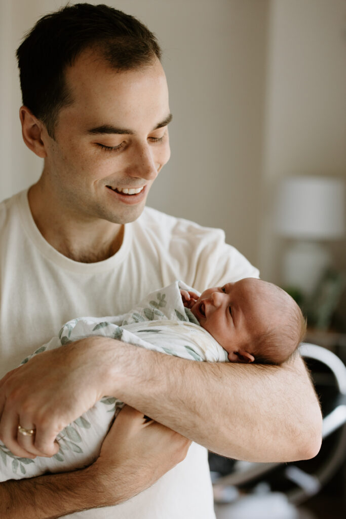 dad holding his newborn daughter